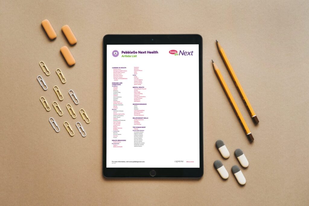 An iPad displaying a blank screen rests on a desk, surrounded by erasers and paperclips, symbolizing an educational workspace.